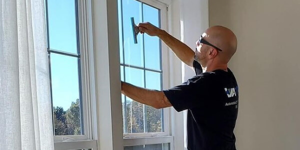 Man tinting windows with film